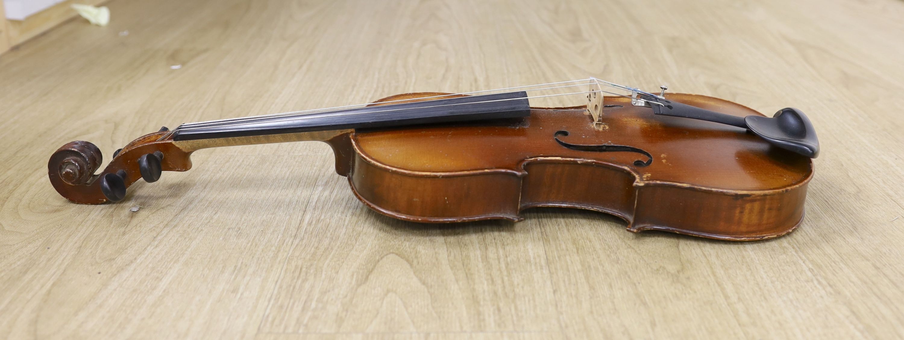 A cased violin, with bow